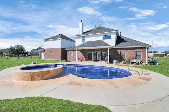 view of pool featuring an in ground hot tub, a yard, and a patio