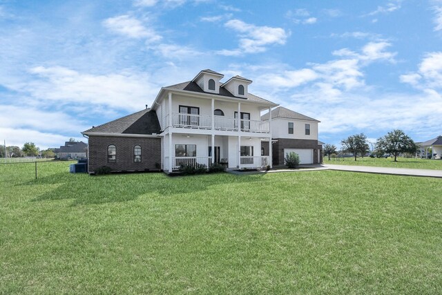 view of front of home featuring a balcony, a front lawn, central AC unit, and a garage