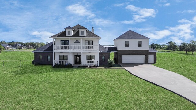 view of front facade with a front lawn, a garage, and a balcony