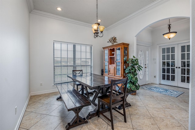 dining space featuring crown molding, light tile patterned floors, and french doors