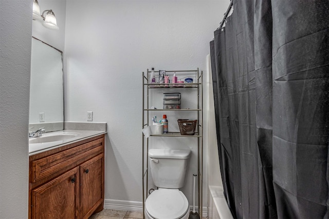 bathroom with vanity, toilet, and tile patterned flooring