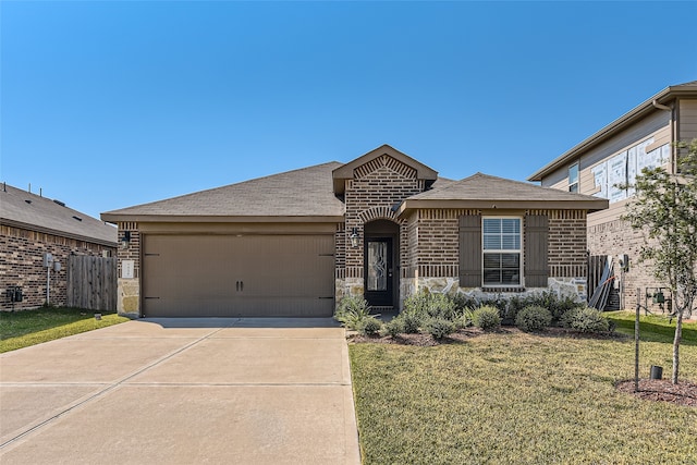 ranch-style house featuring a front yard and a garage