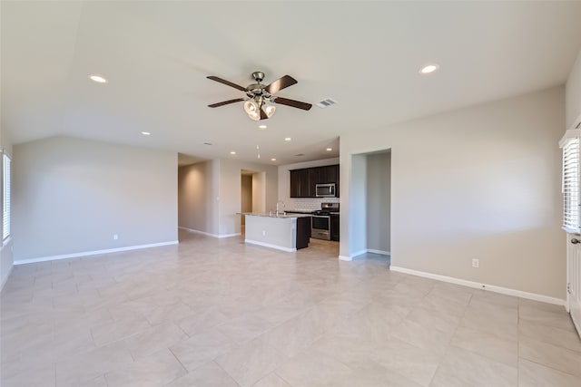 unfurnished living room featuring ceiling fan and sink