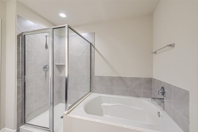 bathroom with separate shower and tub