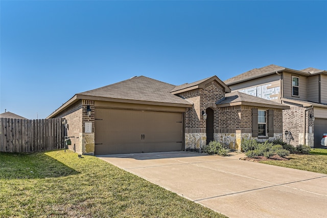 view of front of property with a garage and a front lawn