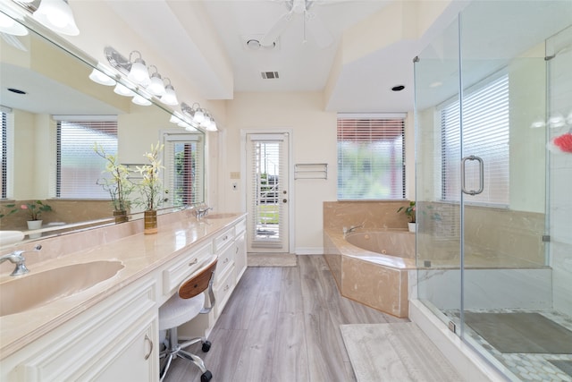 bathroom featuring vanity, separate shower and tub, and hardwood / wood-style floors