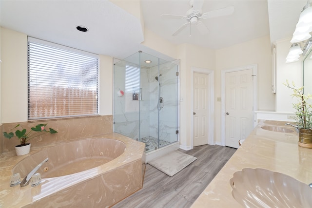 bathroom featuring vanity, plus walk in shower, hardwood / wood-style flooring, and ceiling fan