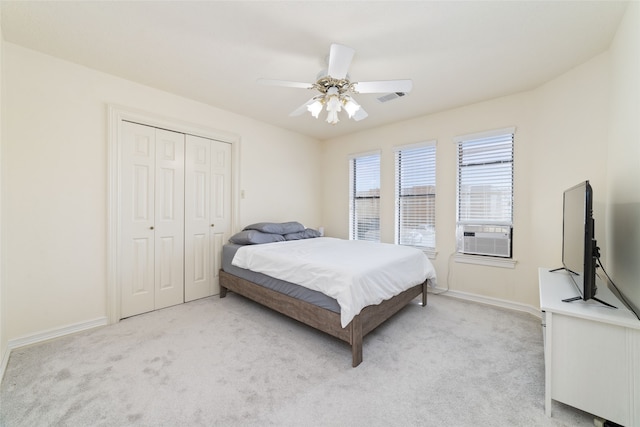 carpeted bedroom with a closet, ceiling fan, and cooling unit