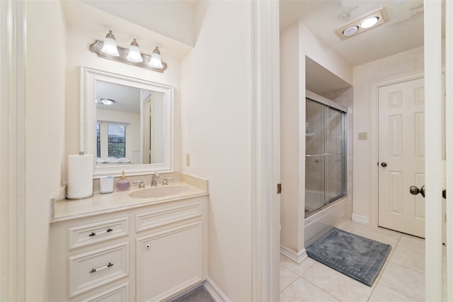 bathroom featuring vanity, shower / bath combination with glass door, and tile patterned flooring