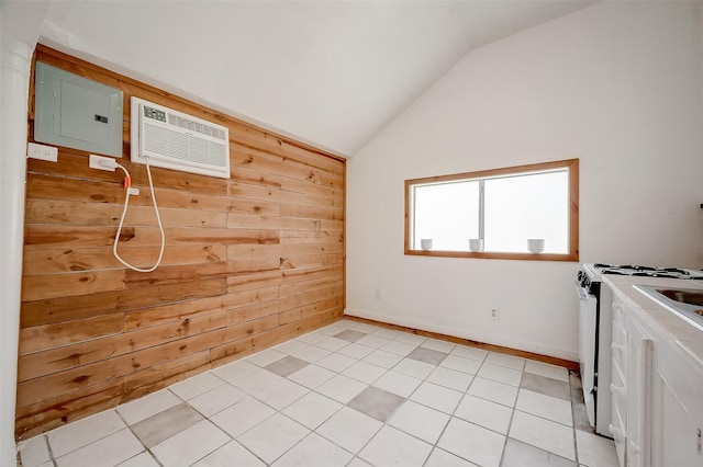 unfurnished room featuring electric panel, vaulted ceiling, a wall mounted air conditioner, wood walls, and light tile patterned floors