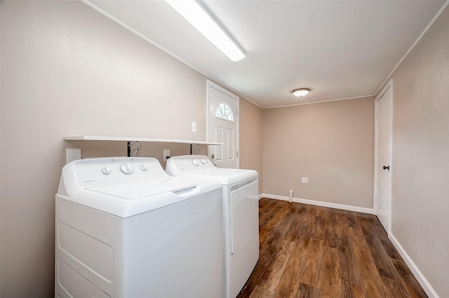 laundry room featuring separate washer and dryer, baseboards, laundry area, and dark wood finished floors