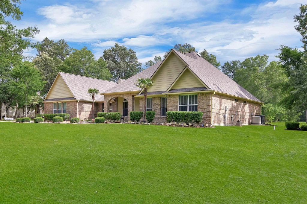 view of front of house featuring a front yard and central AC unit