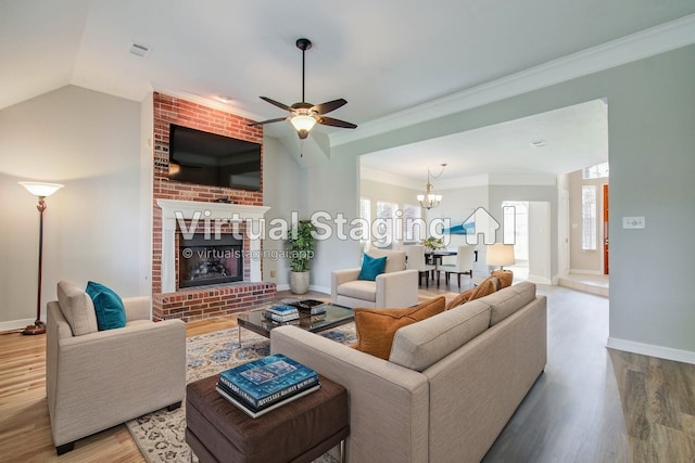 living room featuring lofted ceiling, ornamental molding, wood-type flooring, and a brick fireplace