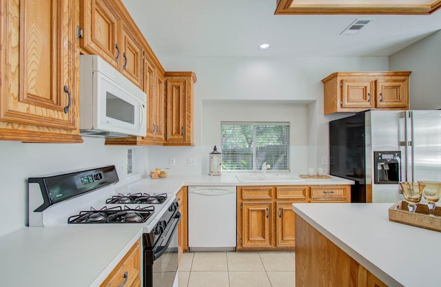 kitchen featuring sink, white appliances, and light tile patterned floors