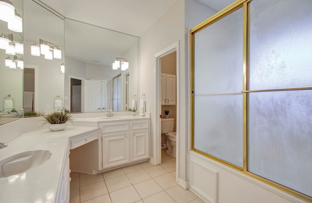 bathroom featuring vanity, tile patterned floors, toilet, and walk in shower