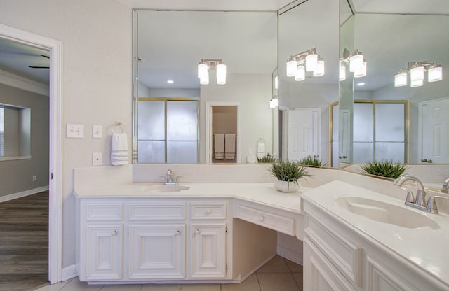 bathroom featuring vanity, ornamental molding, a shower with shower door, and hardwood / wood-style floors