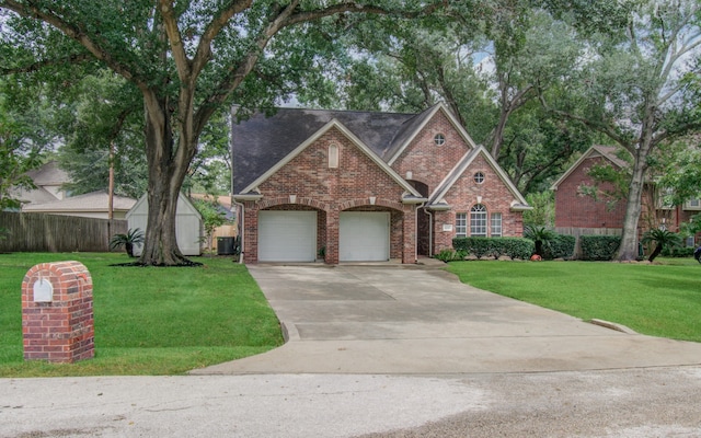 view of front of house featuring a front yard, a garage, and central air condition unit