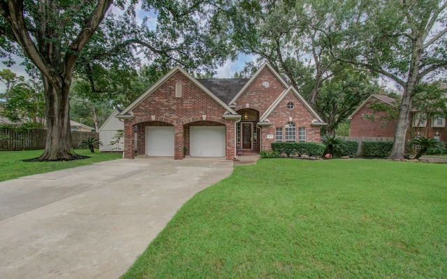 view of front of home with a garage and a front lawn