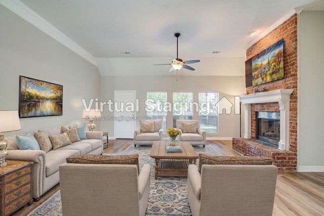 living room featuring light hardwood / wood-style flooring, crown molding, a fireplace, and ceiling fan