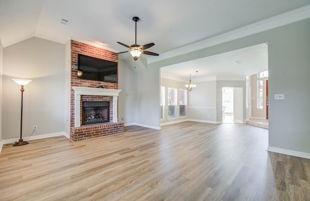 unfurnished living room with ornamental molding, light hardwood / wood-style flooring, a fireplace, and ceiling fan with notable chandelier