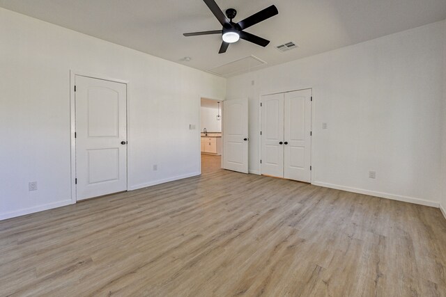 unfurnished bedroom with light wood-type flooring and ceiling fan