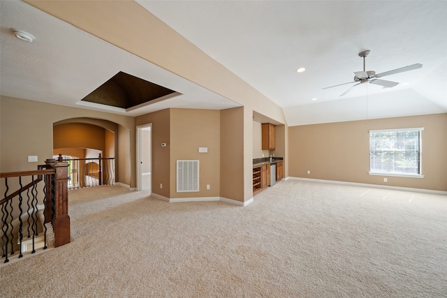 unfurnished living room with light carpet, vaulted ceiling, and ceiling fan