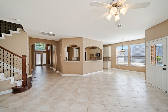 foyer entrance with light tile patterned flooring, sink, plenty of natural light, and ceiling fan