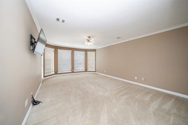 unfurnished room featuring ceiling fan, ornamental molding, and light carpet