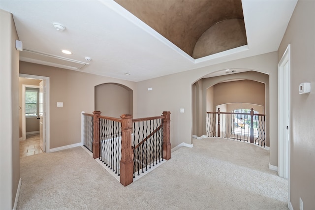 hall with light carpet and lofted ceiling