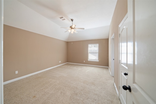 carpeted empty room with vaulted ceiling and ceiling fan