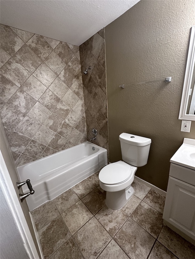 full bathroom featuring a textured ceiling, vanity, toilet, and tiled shower / bath