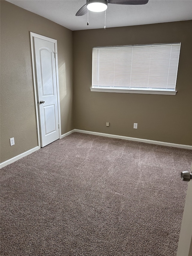 carpeted empty room with ceiling fan