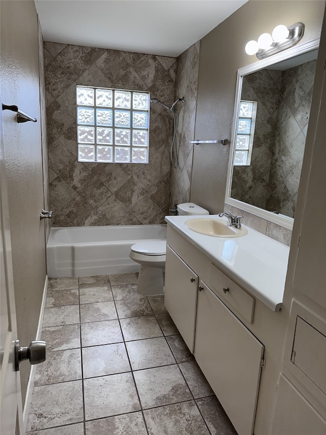 full bathroom with tile patterned flooring, vanity, toilet, and tiled shower / bath combo