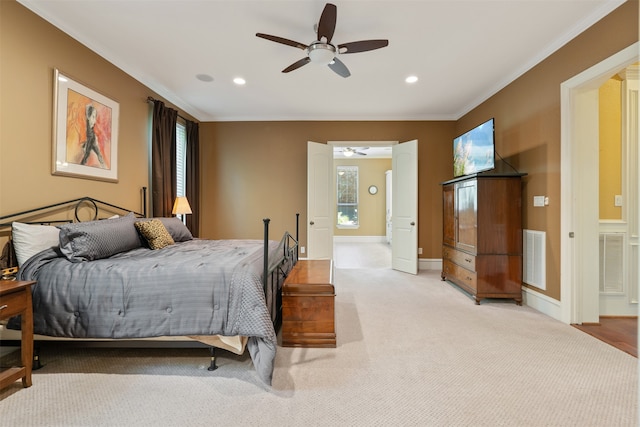 bedroom featuring ornamental molding, light colored carpet, and ceiling fan