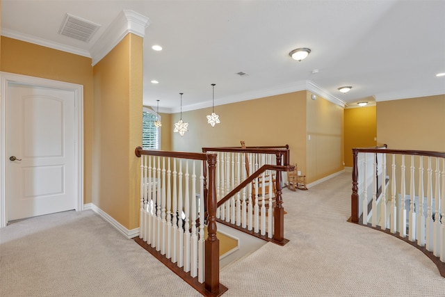 hall with ornamental molding, a notable chandelier, and light colored carpet