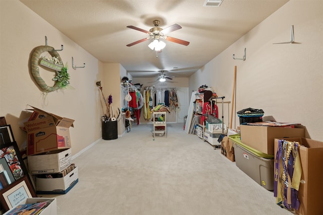 interior space featuring ceiling fan and carpet