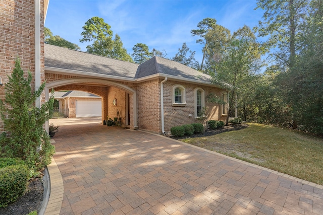 single story home featuring a front yard and a garage