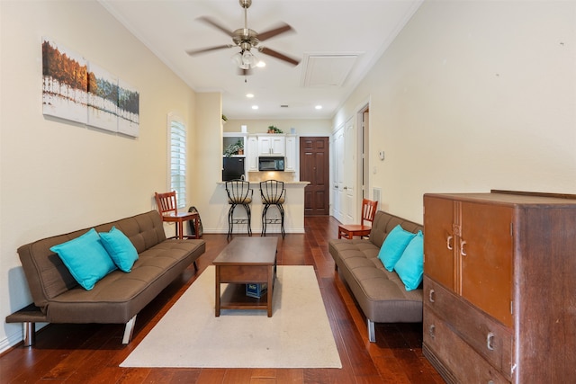 living room featuring crown molding, ceiling fan, and dark hardwood / wood-style flooring