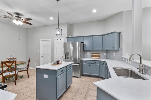 kitchen featuring light tile patterned flooring, hanging light fixtures, sink, and stainless steel refrigerator with ice dispenser