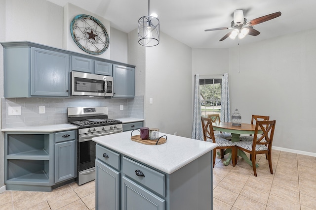 kitchen featuring backsplash, appliances with stainless steel finishes, a center island, and light tile patterned floors