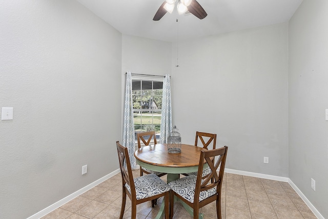 dining space with light tile patterned floors and ceiling fan