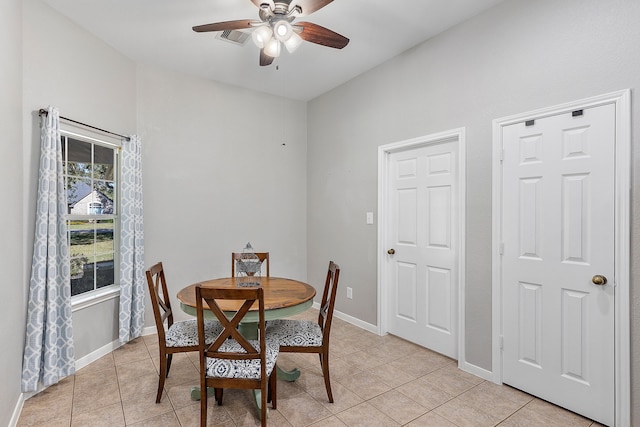 tiled dining space featuring ceiling fan