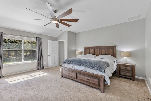 bedroom featuring ceiling fan, light carpet, and vaulted ceiling