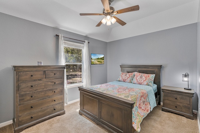 carpeted bedroom with vaulted ceiling and ceiling fan