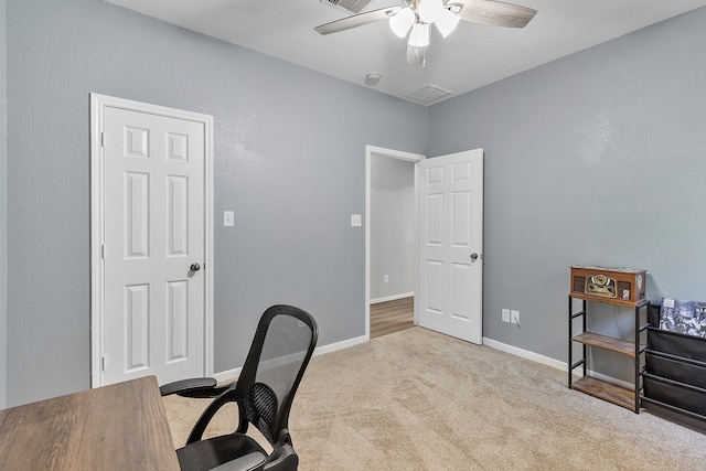 office space with light carpet and ceiling fan