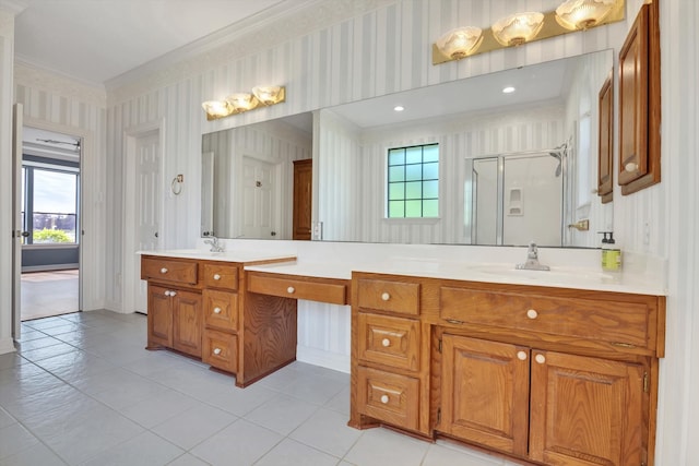 bathroom with a shower with door, tile patterned floors, ornamental molding, and vanity