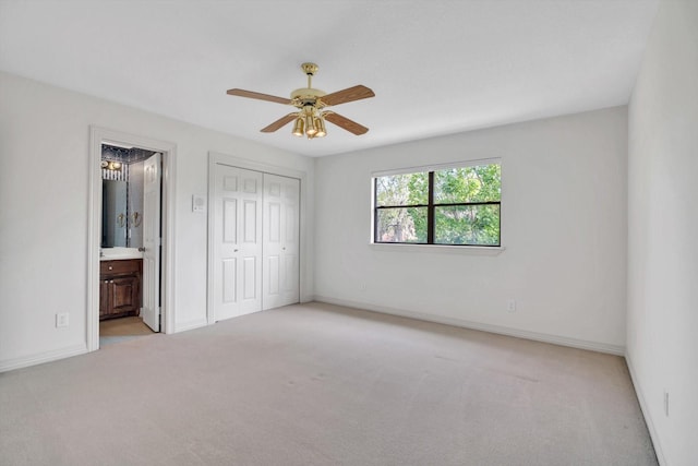 816 Lake Rd, Lake Jackson, TX 77566 - unfurnished bedroom with light carpet, a closet, connected bathroom, and baseboards