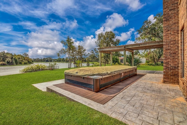 816 Lake Rd, Lake Jackson, TX 77566 - view of green lawn with a covered hot tub, a water view, and a patio