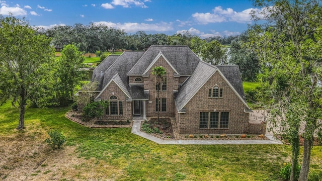 816 Lake Rd, Lake Jackson, TX 77566 - view of front of home with a front lawn, brick siding, and view of scattered trees