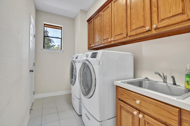 816 Lake Rd, Lake Jackson, TX 77566 - laundry room featuring cabinet space, washing machine and clothes dryer, light tile patterned flooring, and baseboards